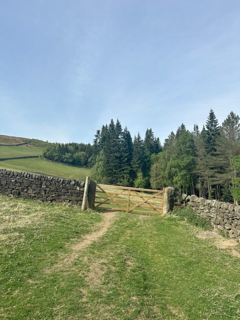 A wooden gate over a track