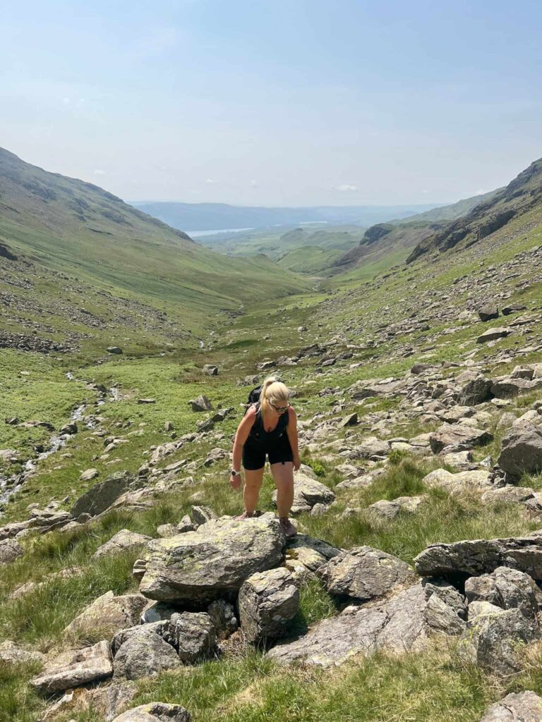 A woman hiking through a boulder field