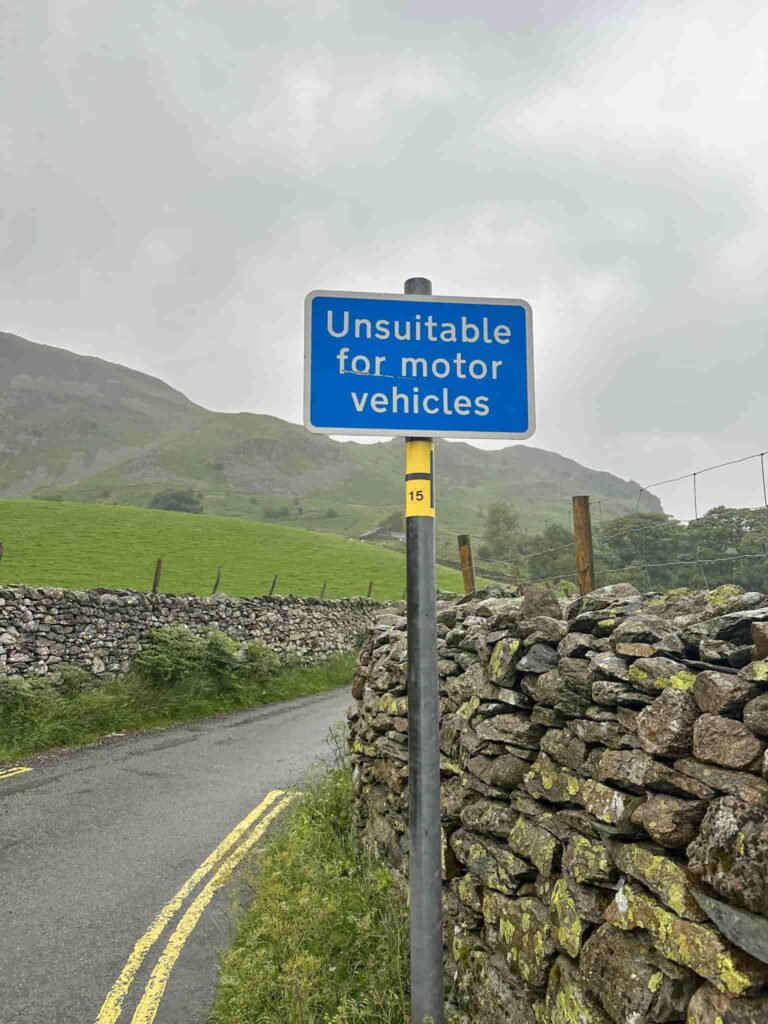 "Unsuitable for motor vehicles" blue sign