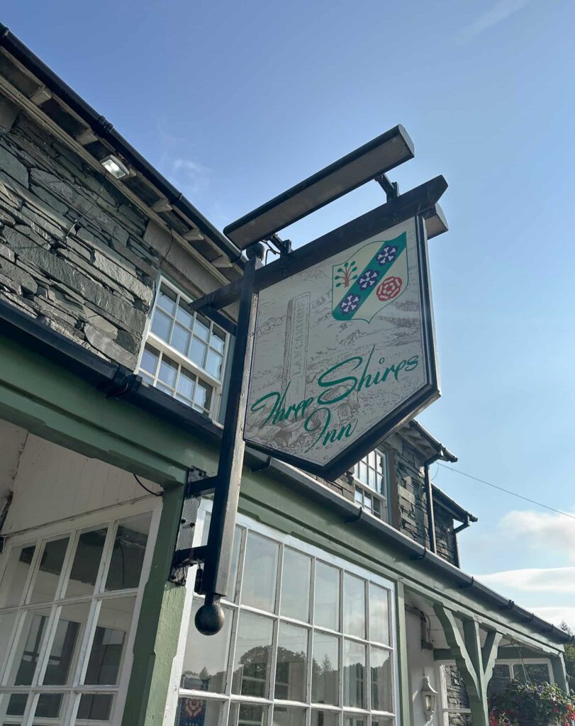 Pub sign for Three Shires Inn