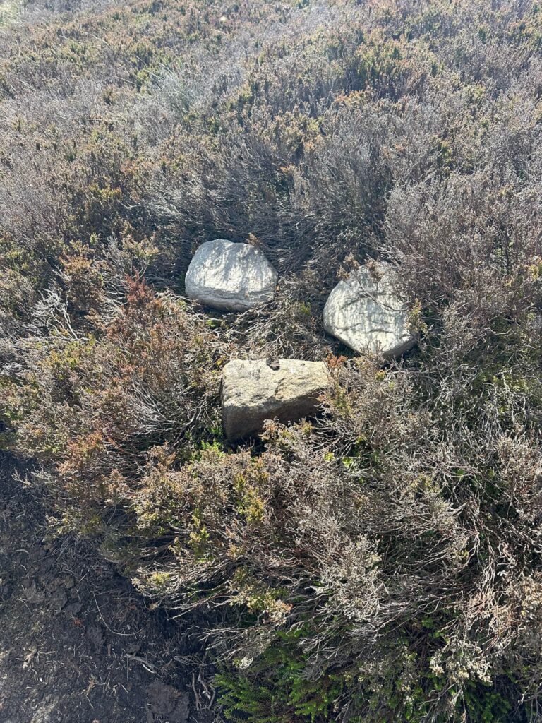 Some stones in the heather marking the turning