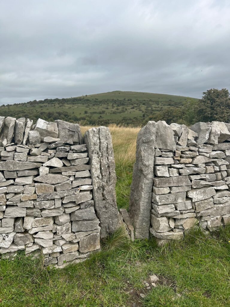 A stile with a view over to Wardlow Hay Cop