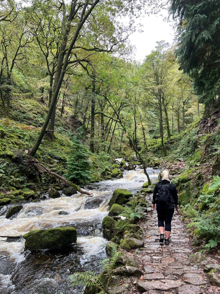 A woman walking next to Stanley Ghyll