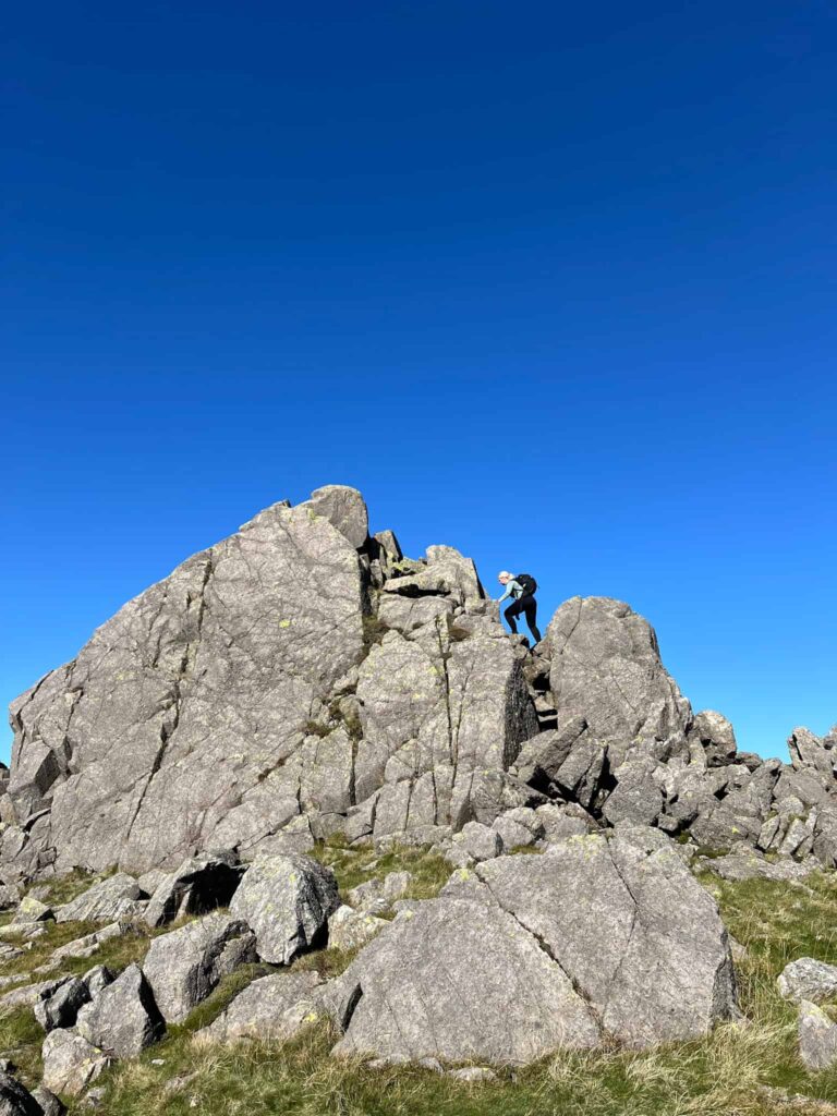 A woman climbing on Harter Fell