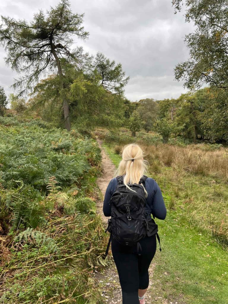 A woman walking in some woods