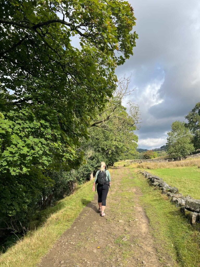 A woman walking along a riverside path