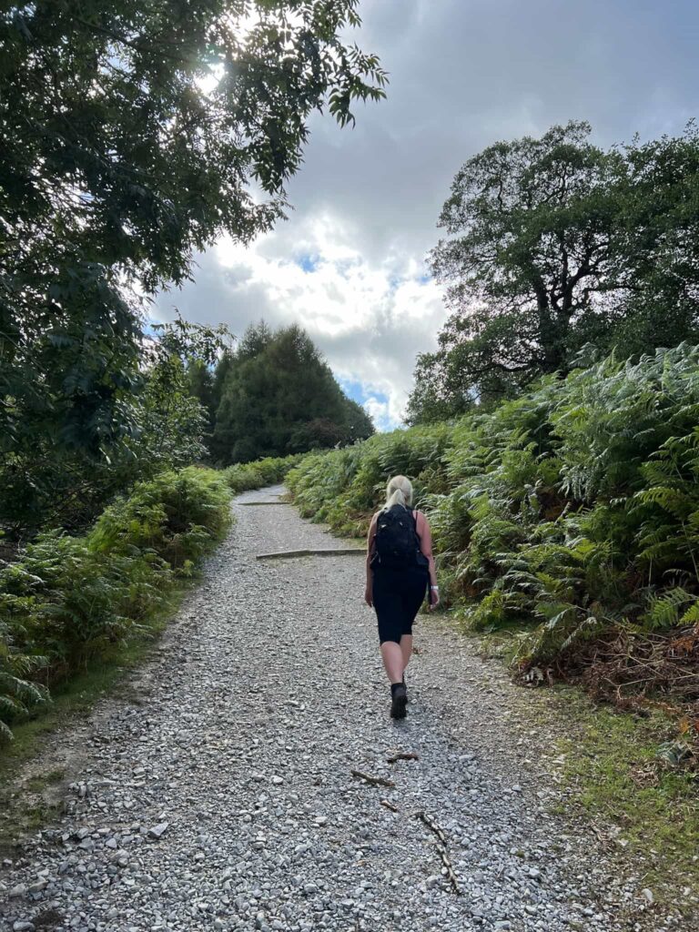 A woman walking up a rough track