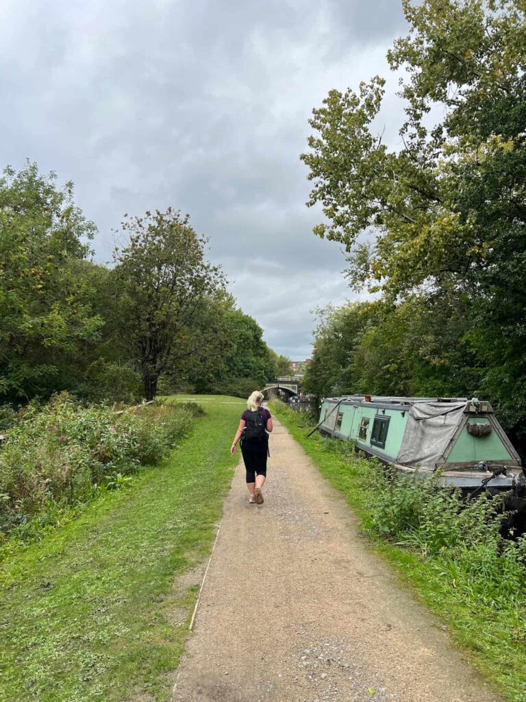 A woman walking on a canal towpath