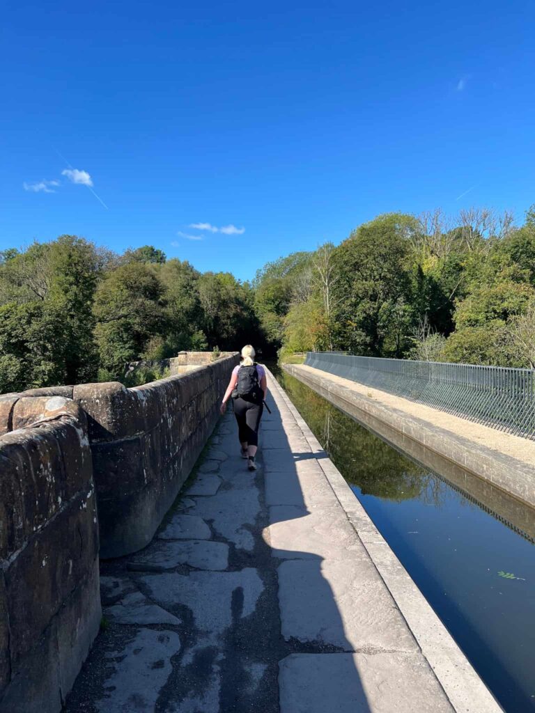 A woman walking over the Marple Aqueduct