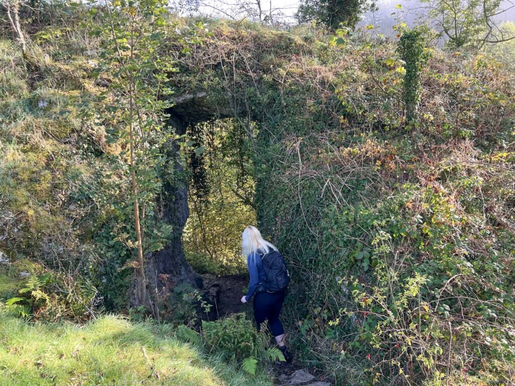 A woman exploring Cucklet Church, Eyam