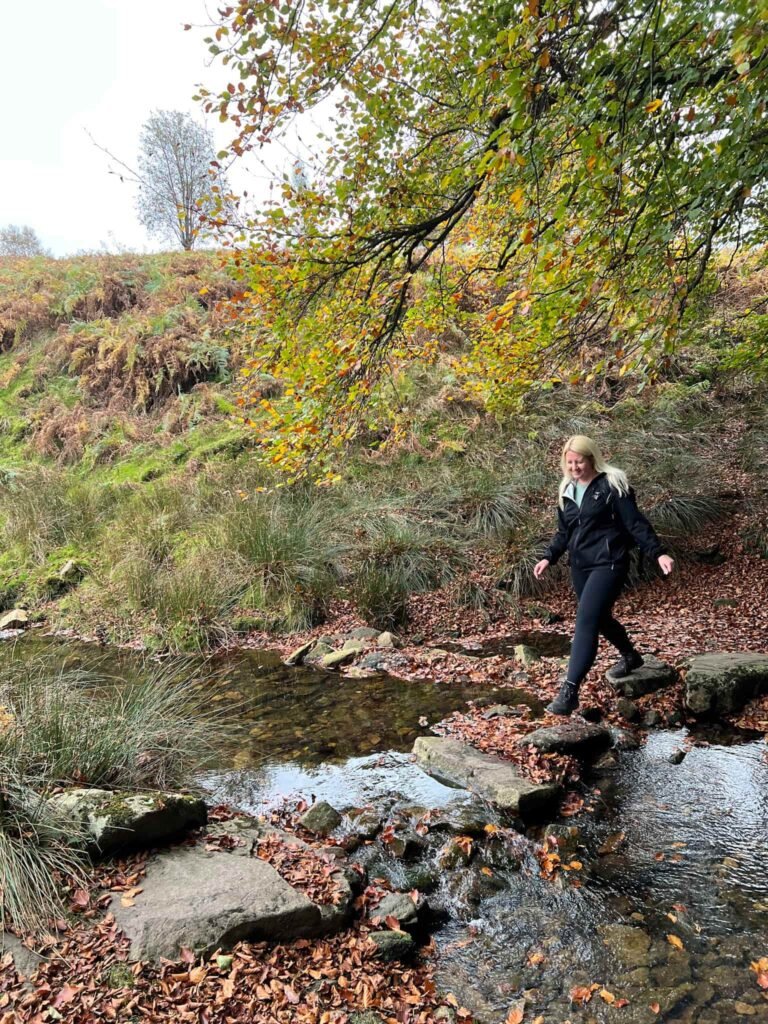 A woman crossing a stream