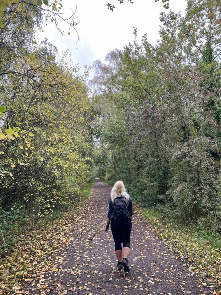 A woman walking on the Sett Valley Trail