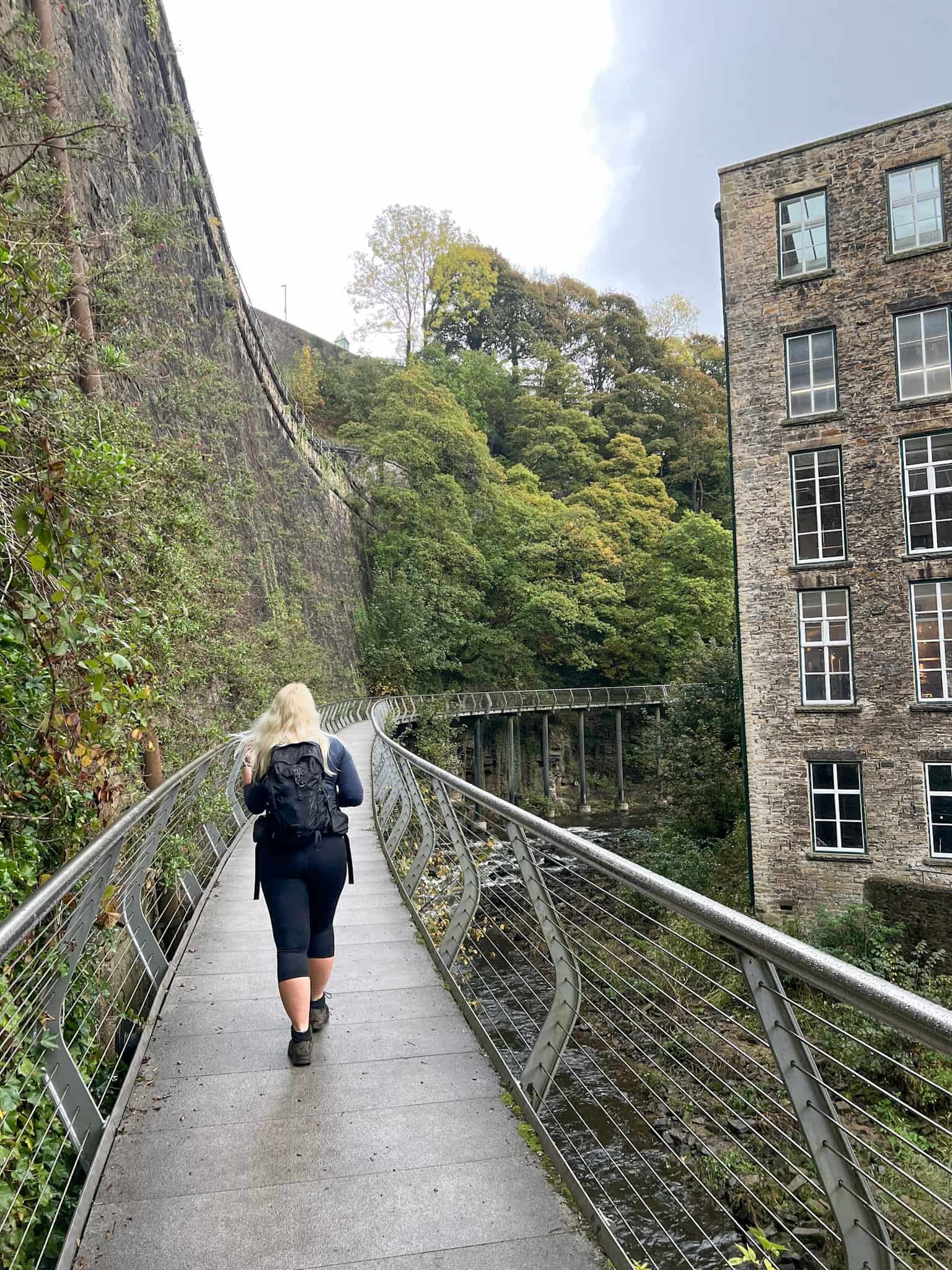 A woman walking on the Millennium Walkway, New Mills