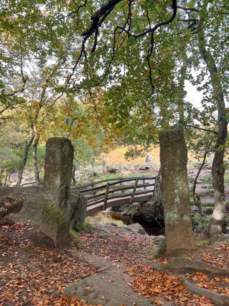 Some old stone gateposts with a bridge view beyond
