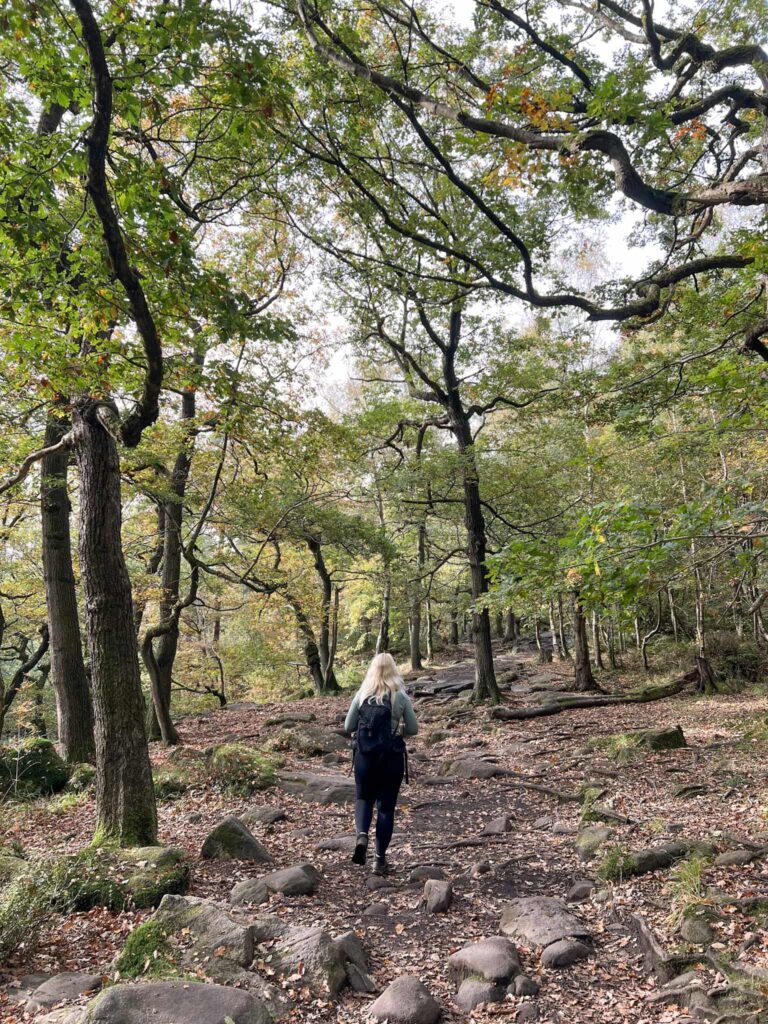 A woman walking in Padley Gorge