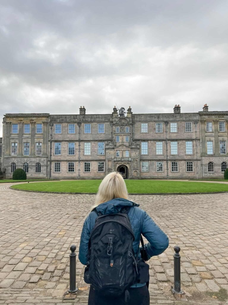 A woman looking up at Lyme Park