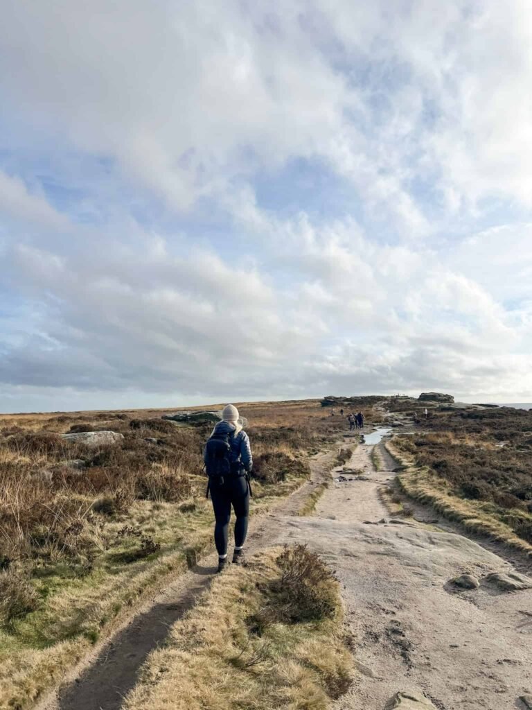 A woman walking on Curbar Edge