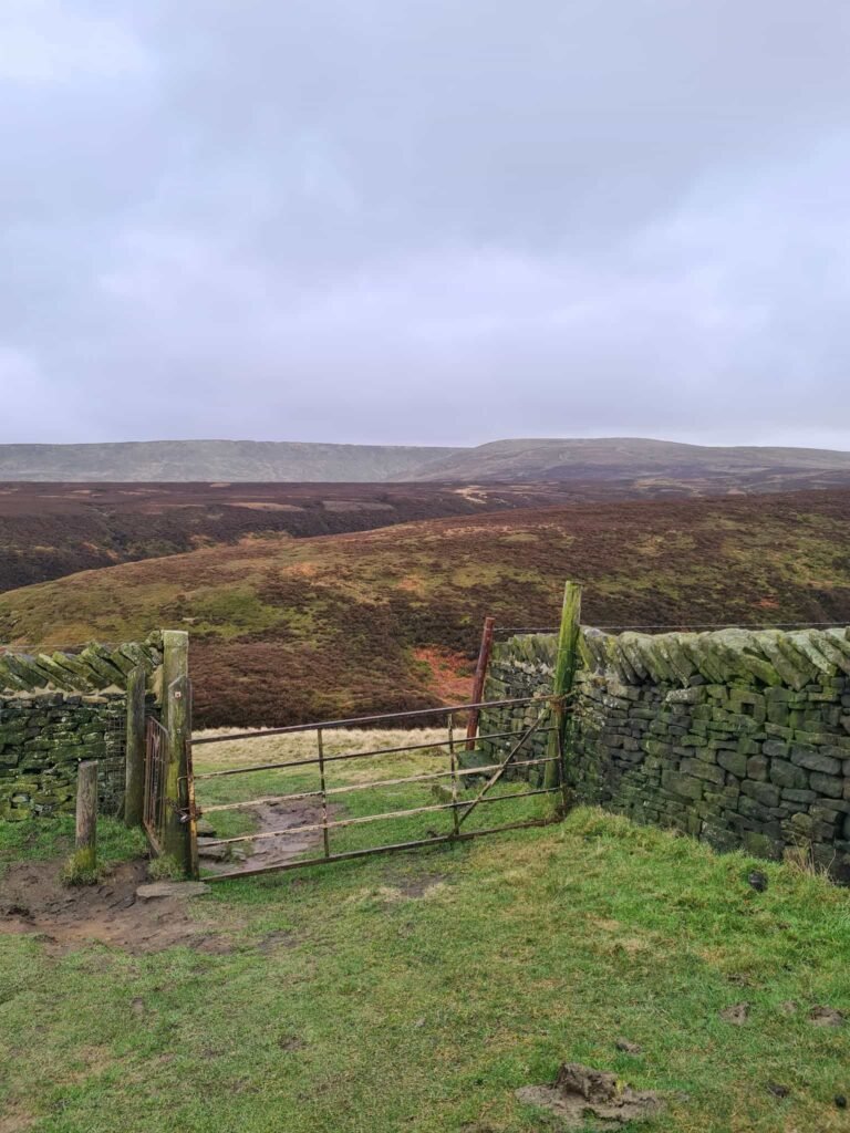 A metal gate overlooking moorland