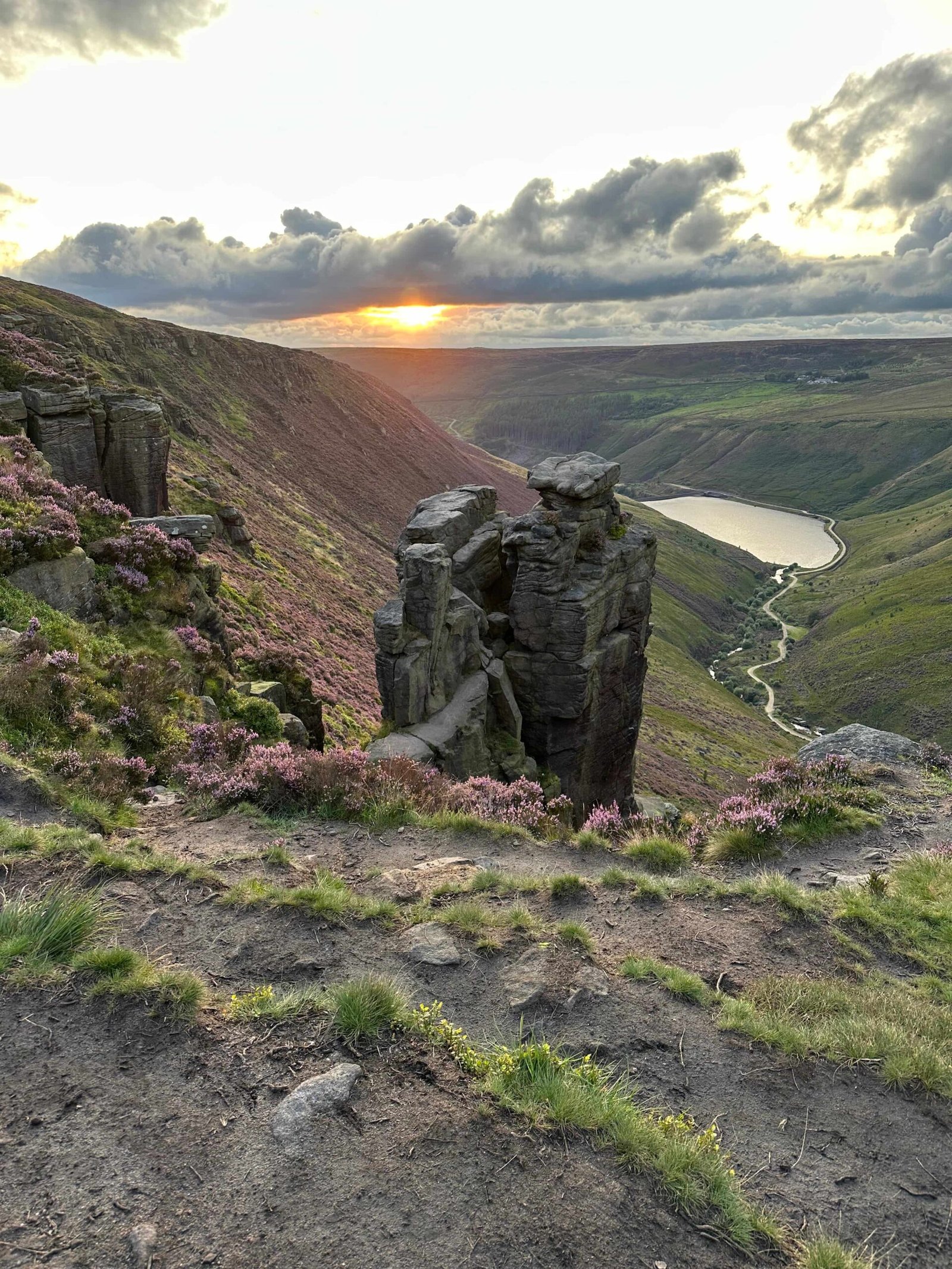 The Trinnacle rock formation at Dove Stone Reservoir at sunset