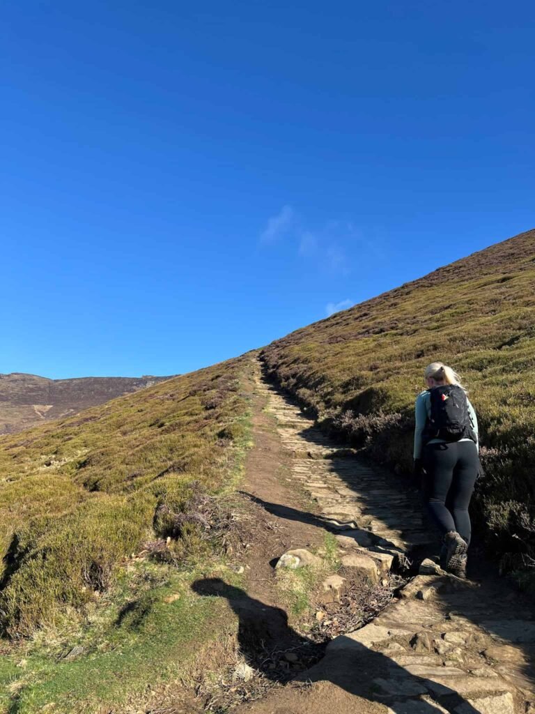A woman walking up Ringing Roger