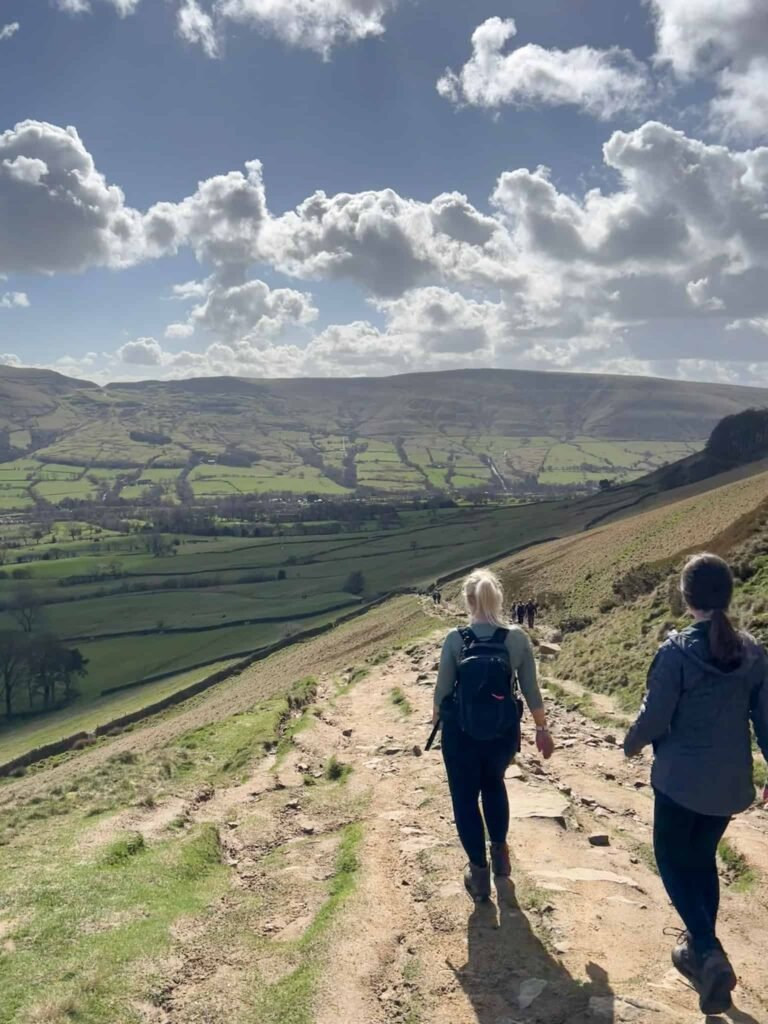 A woman and her daughter walking down a rocky path