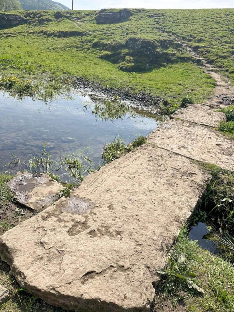 An old stone clapper bridge over the River Bradford