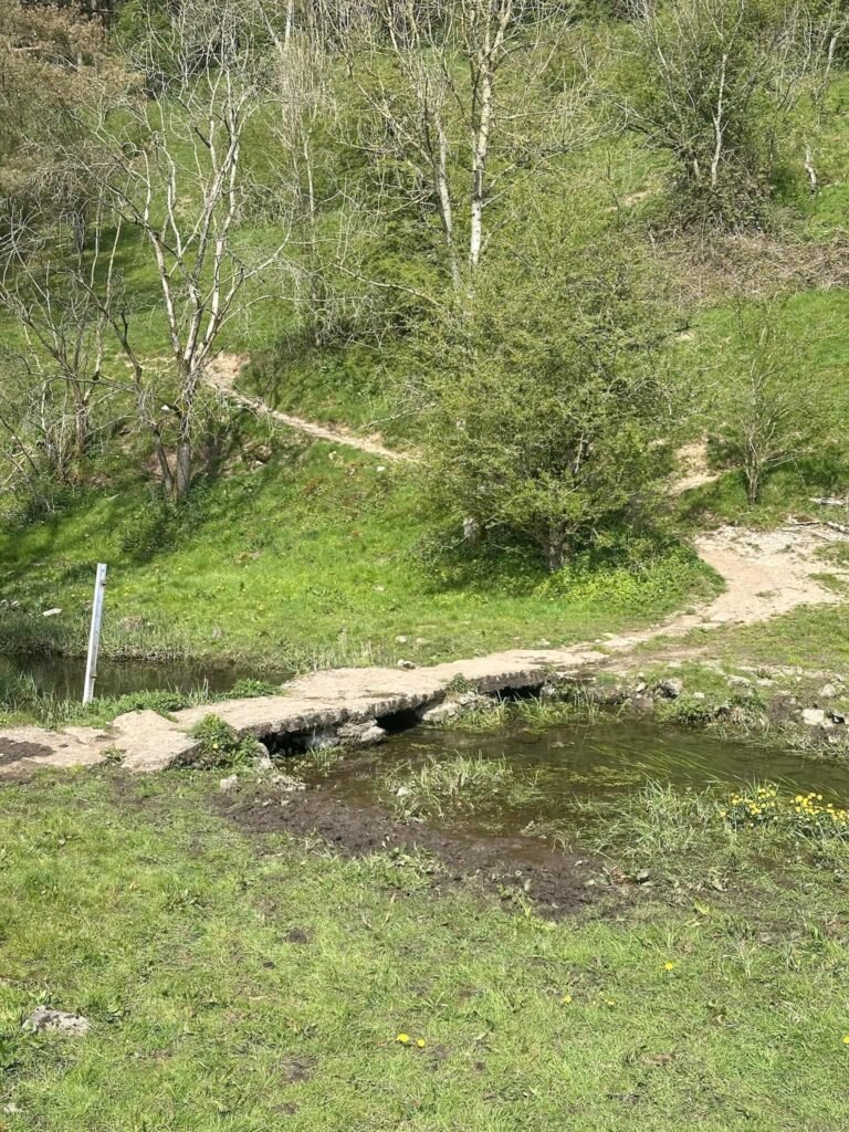 An old stone clapper bridge over the River Bradford