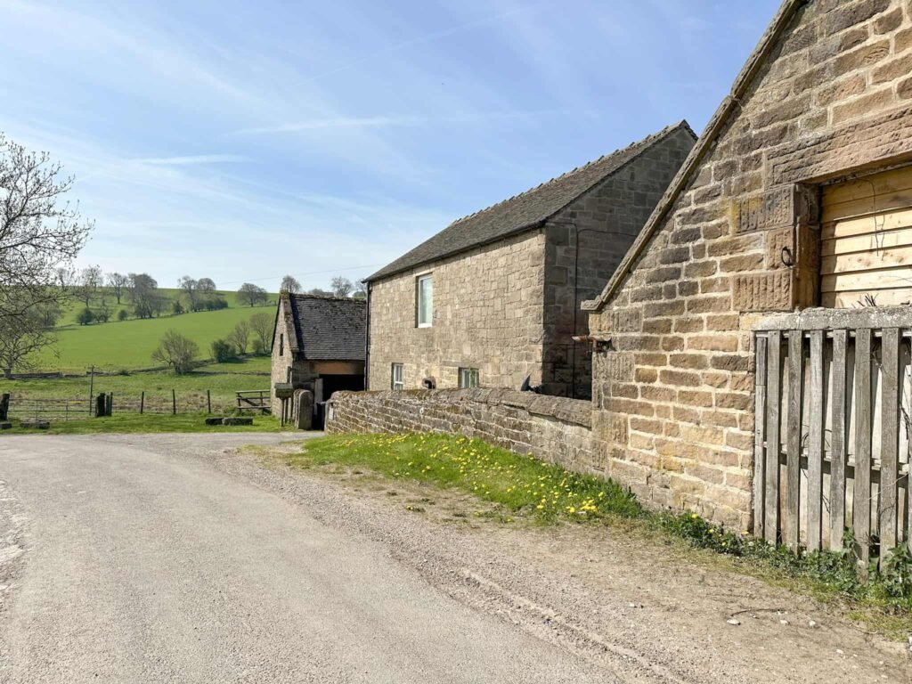 A road leading alongside a farm