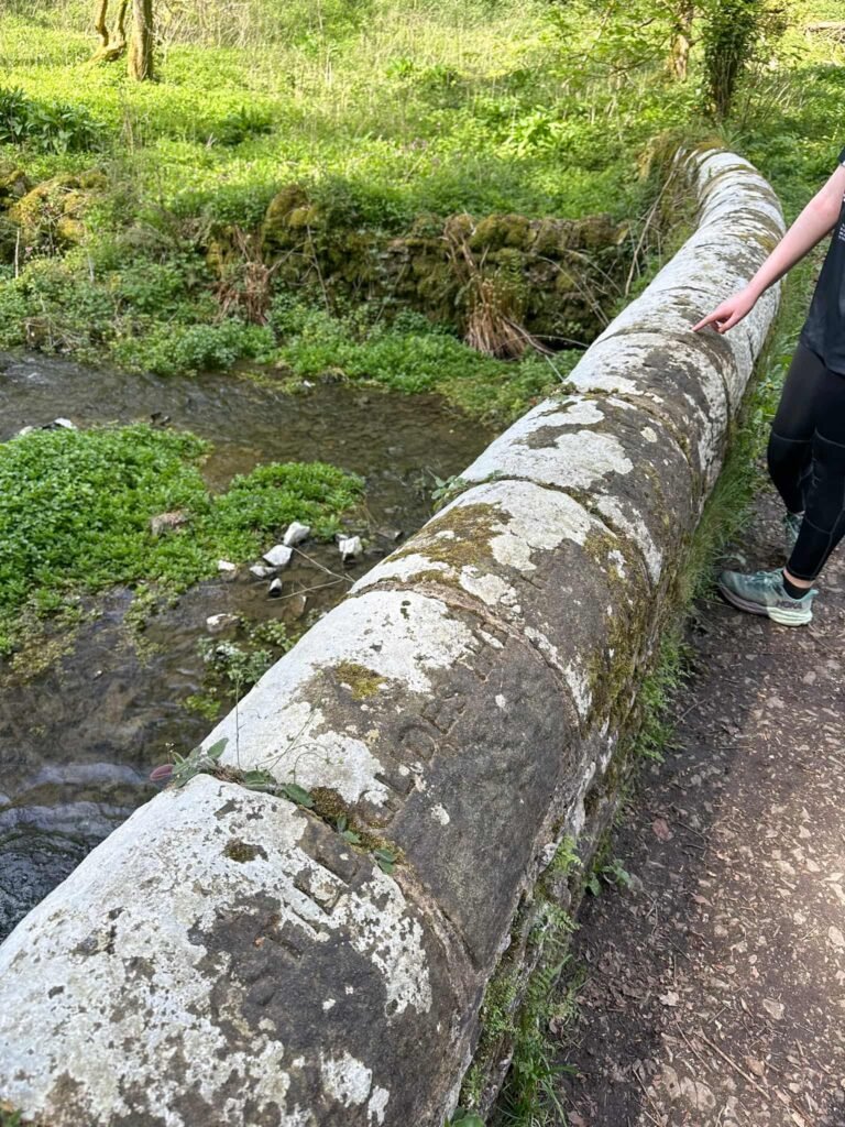 Wording inscribed onto a stone bridge - it's hard to make it out.