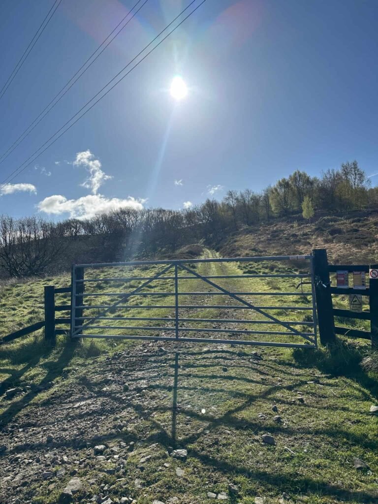 A metal gate leading to moorland