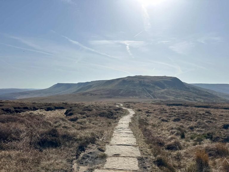 A flagged path with Kinder Scout in the background