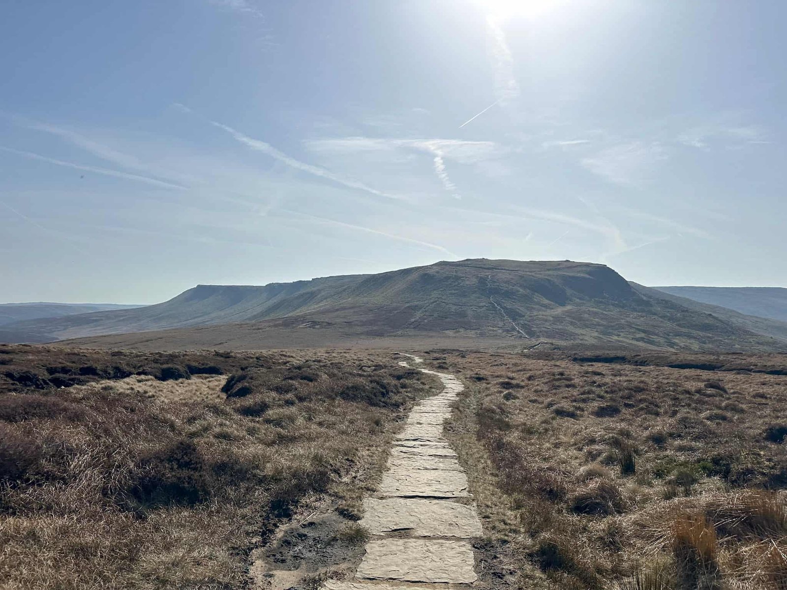 A flagged path with Kinder Scout in the background