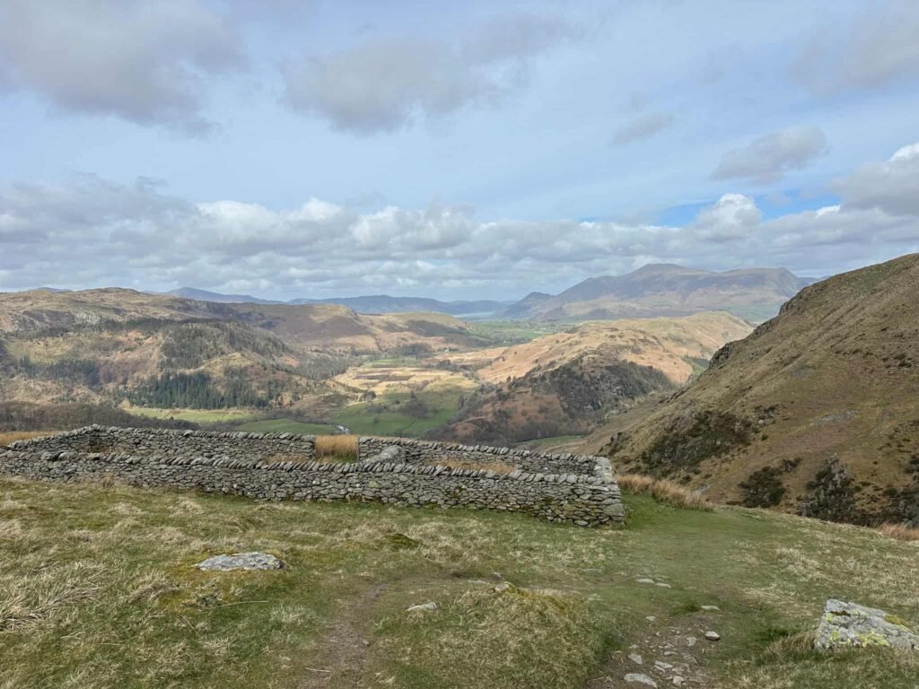 A stone built sheepfold on Stybarrow Dodd with views over to Blencathra
