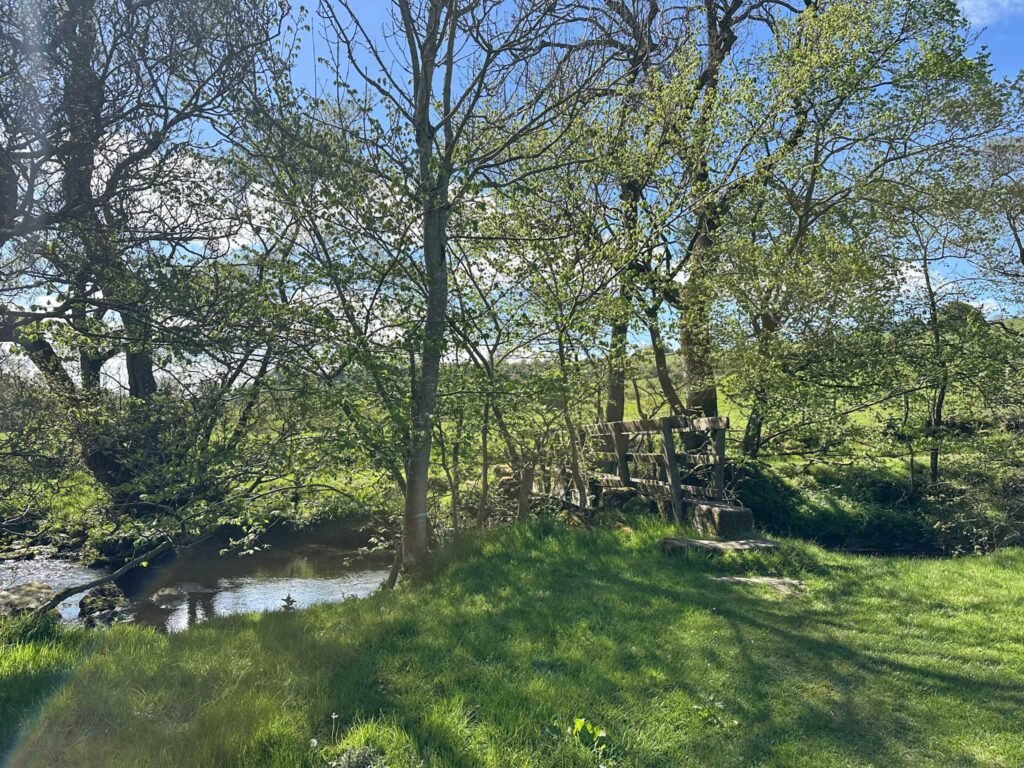A wooden bridge over the River Dove