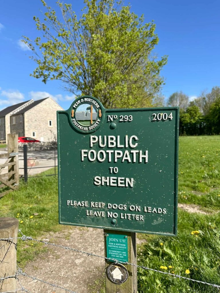A green sign with white writing, saying Public Footpath to Sheen