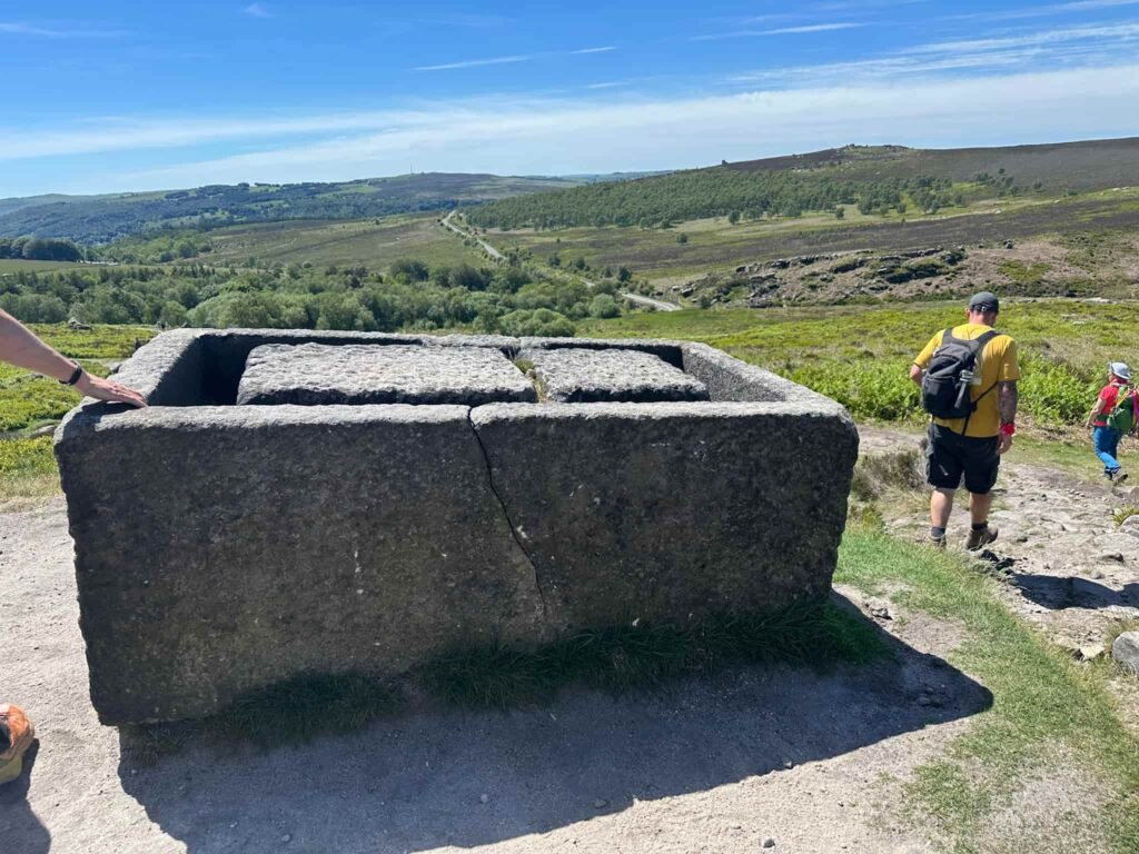 An old stone trough, abandoned midway through carving as there's a big crack running down it