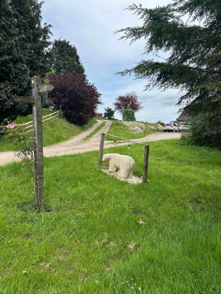 A polar bear statue in a garden