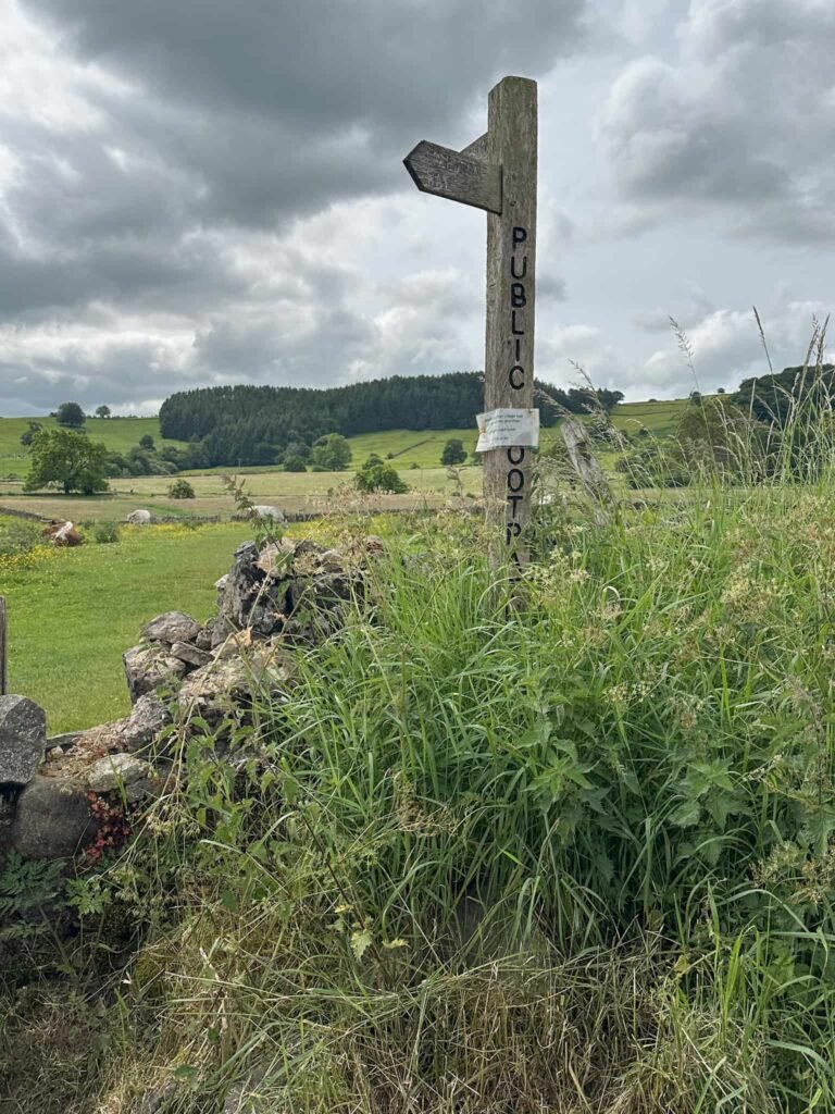 A wooden footpath sign