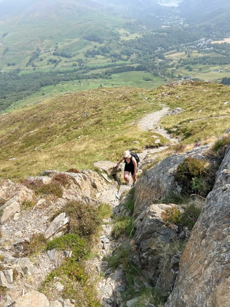 A woman on the short scramble section of Moel Hebog