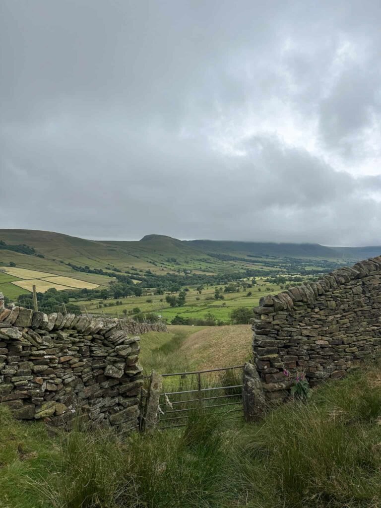 A metal gate with a view over to Mam Tor, Back Tor and Lose Hill