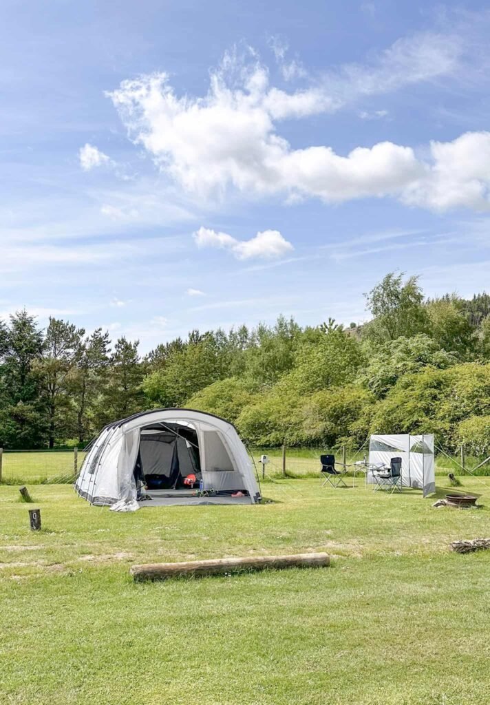 A grey tent on a campsite