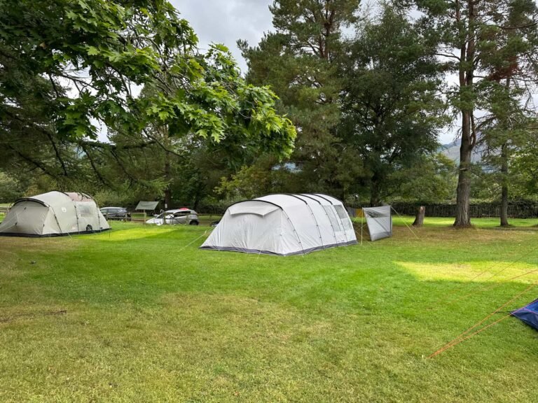 A grey tent in a camping field