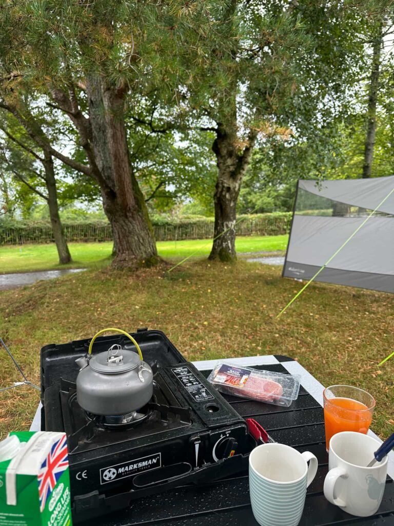 A view of a camping gas stove with a kettle