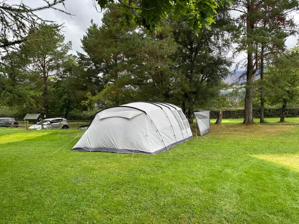 A grey tent in a camping field