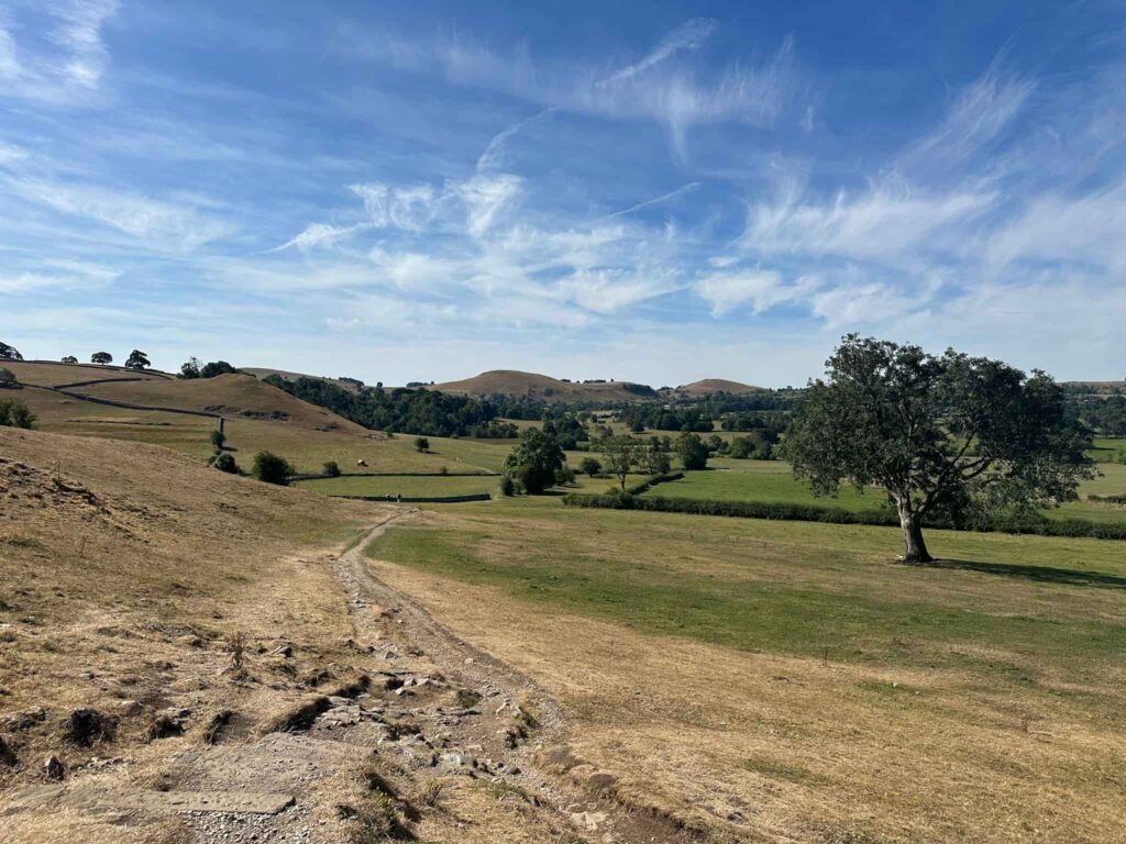 A grassy footpath through countryside near Hartington