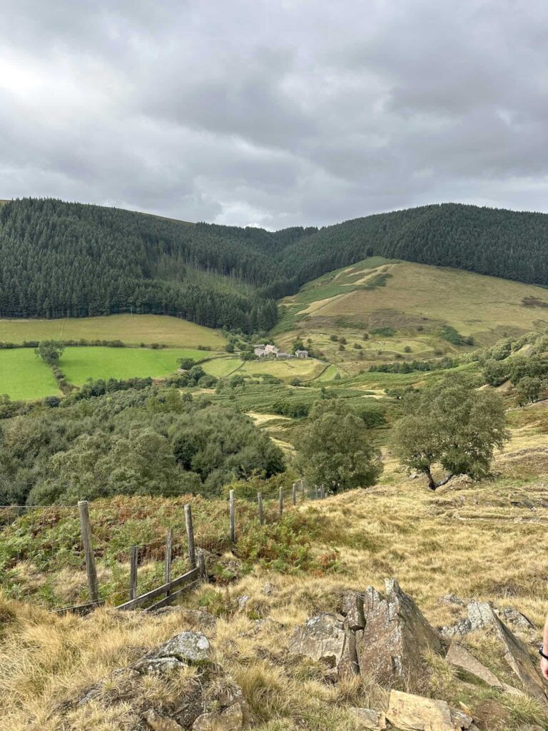 A view of a small farm surrounded by countryside