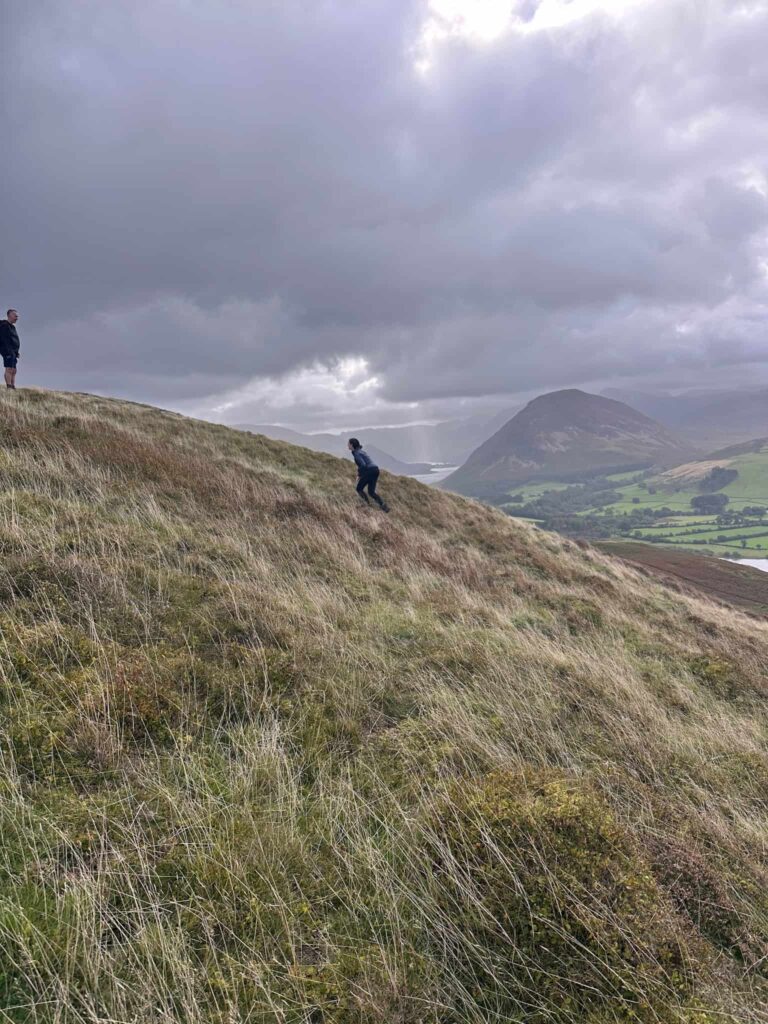 A teenager walking up a very steep hill