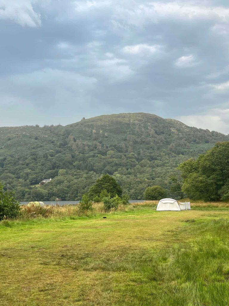 A small grey tent in a camping field