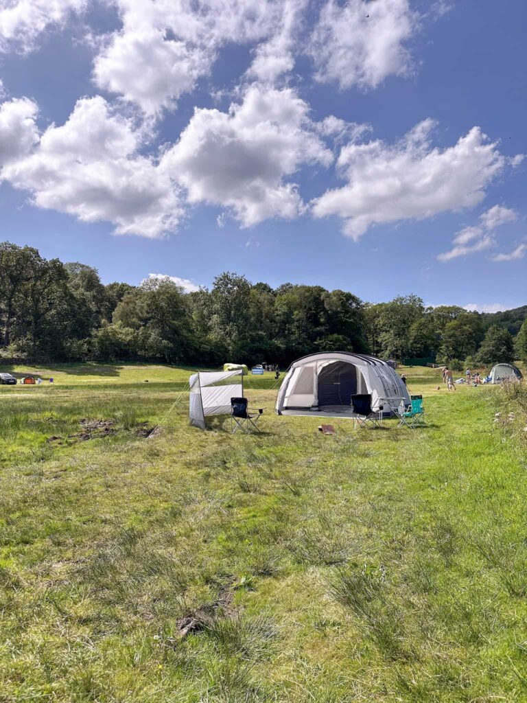 Grey tent on a camping field 
