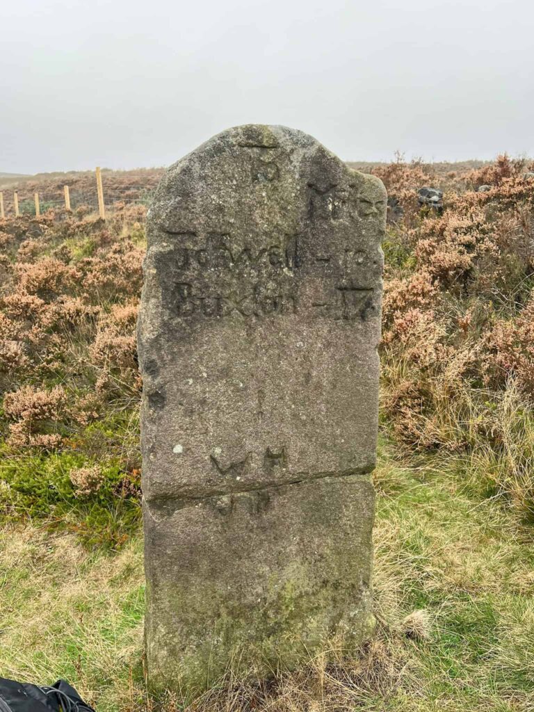 A milestone on Houndkirk Road with directions to Tideswell and Buxton